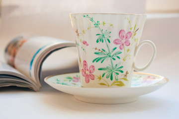 Coffee mug with newspaper on teal rustic table, cozy breakfast, vintage style