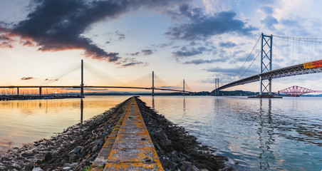 Sunset at famous bridge with birds flying through
