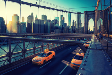 Cubs speeding at sunset on Brooklyn Bridge, Manhattan. One of the most iconic bridges in the world,...