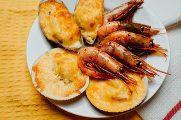 scallops and mussels in the shell, fried shrimp on a yellow background