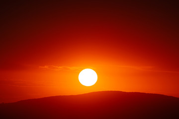 Beautiful sunset sky above clouds with dramatic light.