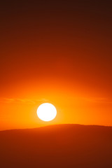 Beautiful sunset sky above clouds with dramatic light.
