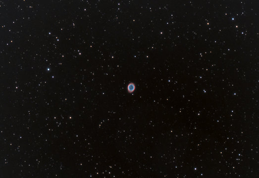 Close up of Ring Nebula also known as Messier 57 taken in the dark space and many stars as background.