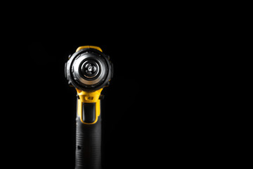 Electric drill closeup on a black background with wood and drills. Electrical tools. Hand battery screwdriver.