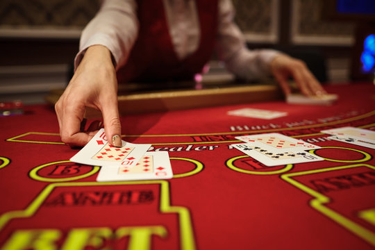 The croupier in the casino does a shuffle of cards