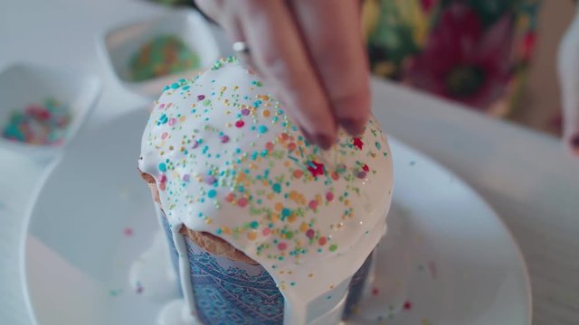 Powdering an Easter cake with colored caramel. 4K