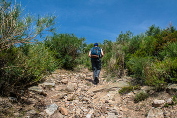 man walks to the peak of the mountain
