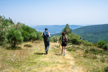 youngman and woman down their way on the mountain