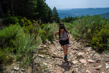 young woman make their way on the mountain