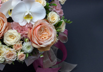 mixed bouquet of flowers close up white orchid dark background