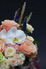 mixed bouquet of flowers close up white orchid dark background