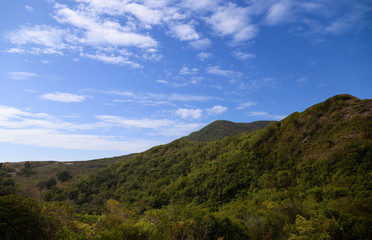 Fototapeta na wymiar Green moutain hill and clear blue sky