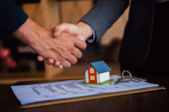 Real estate agent shaking hands with customer, Successful deal after meeting, Concept of real estate and deal.