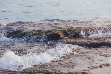 golden sunset on the sea shore and footprints in the sand