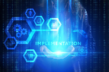 Obraz premium The concept of business, technology, the Internet and the network. A young entrepreneur working on a virtual screen of the future and sees the inscription: Implementation