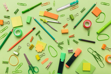 Flat lay of office, school stationery on green background