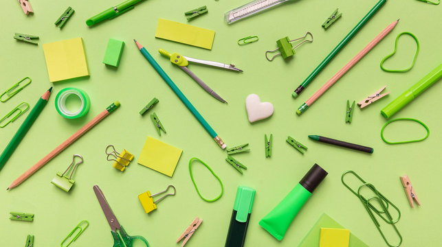 Flat lay of office, school stationery on green background