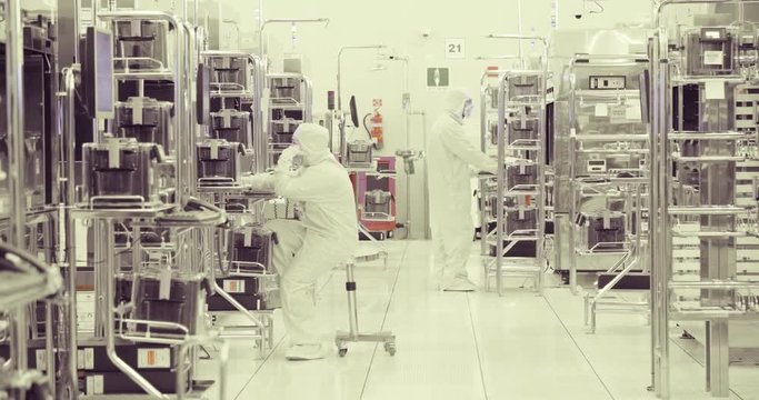 Workers in clean room in a semiconductors manufacturing facility