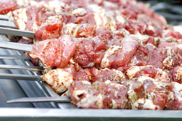 Raw pork meat skewer ready for grill. Marinated meat for barbecue. Fresh shish kebab on skewers ready for cooking on grill