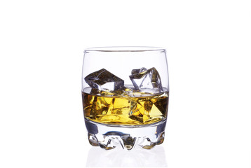 A glass of whiskey with ice cubes on a white background.