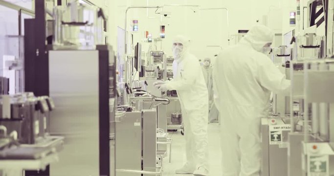 Workers in clean room in a semiconductors manufacturing facility
