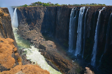 Victoria Falls, or Mosi-oa-Tunya (Tokaleya Tonga: The Smoke That Thunders), is a waterfall in...