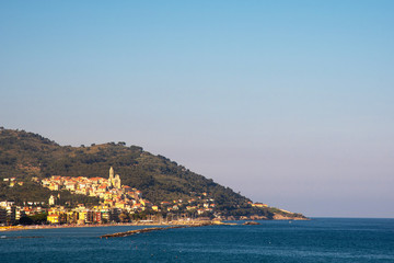 Scenic view of the Dianese Gulf with the old fishing village of Cervo Ligure on the coastline with Cervo Cape in the background at sunset, Imperia, Liguria, Italy
