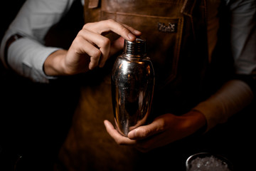 Close-up of a shaker in bartender's hands