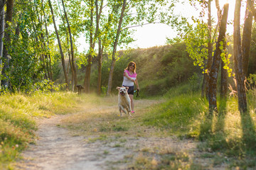 Fototapeta premium Middle-aged woman plays with her dog