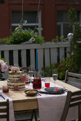 tiered wedding cake with flowers on terrace