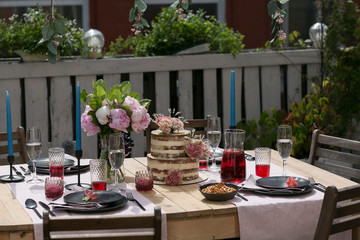 tiered wedding cake with flowers on terrace