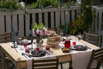tiered wedding cake with flowers on terrace