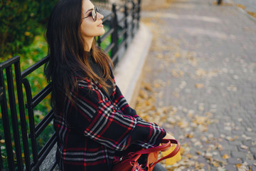 stylish girl exploring the city and park in the autumn