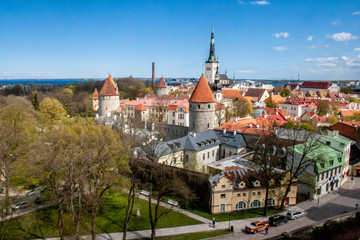 Naklejka na ściany i meble Beautiful scenic aerial view of the Tallinn old town, Estonia with towers and churches, Baltic sea on the background