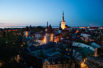 Beautiful scenic aerial view of the Tallinn old town, Estonia with towers and churches, Baltic sea on the background, summer night