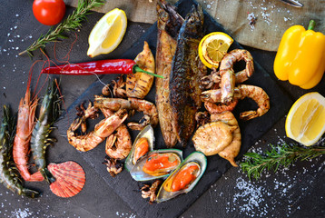 Mediterranean dinner with grilled shrimps, mussels, squids and fish. View above.