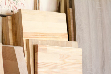 Wooden pillars and thick boards in the furniture workshop are ready to work joiner, selective focus