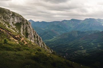 Landscape view of cloudy mountains in Asturias, Spain during summer. 