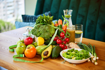 Diet weight loss breakfast concept with tape measure, organic fruits , vegetables, salad and fresh water. Healthy nutrition concept, Lifestyle and Eating