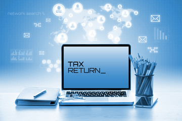 Open laptop with notebook and smartphone. Tax and Technology Concept