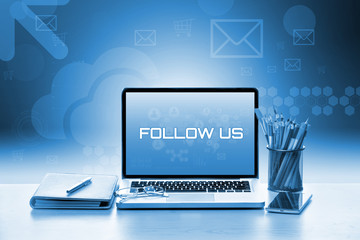 Open laptop with notebook and smartphone. Contact Us Concept