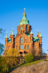 Fototapeta na wymiar Helsinki, Finland - May 9 2019: Red Church - Uspenski Orthodox Cathedral on a rocky hill