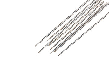 rusty hand-sewing needles close-up on white background.