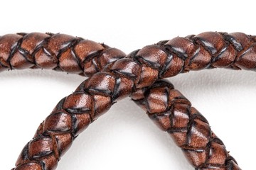 handcrafted leather rope on white background with selective focus