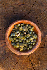 caper in a wood bowl