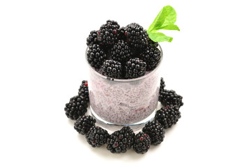 Fototapeta na wymiar Chia pudding with mint and blackberry on a white background. Space for text or design.