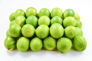 Many fresh limes on white background.