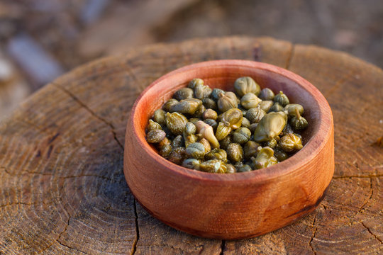 caper in a wood bowl