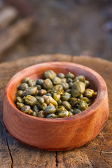 caper in a wood bowl