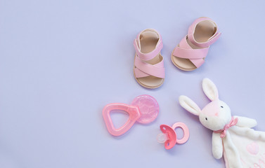 Fototapeta premium the pink baby shoes, pacifier, teether and rabbit toy